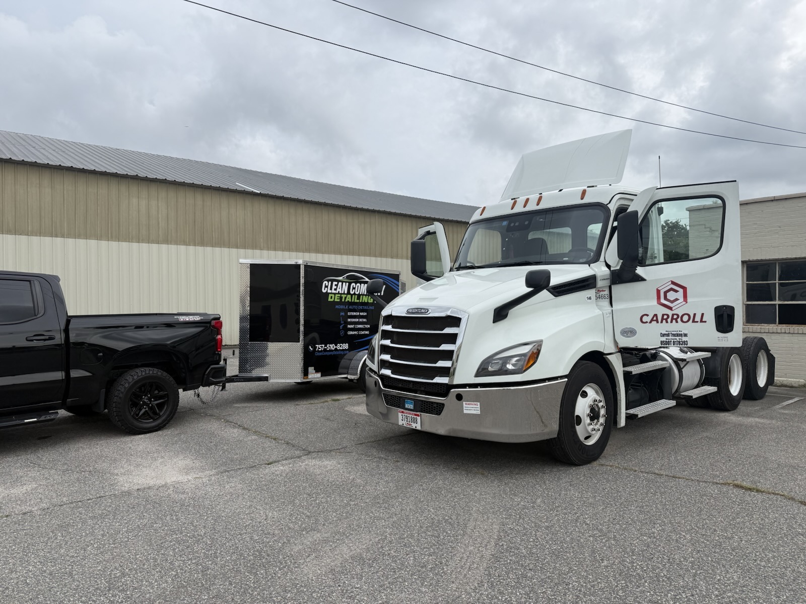 Clean Company Detailing truck and trailer parked beside a white semi-truck cab at a commercial lot